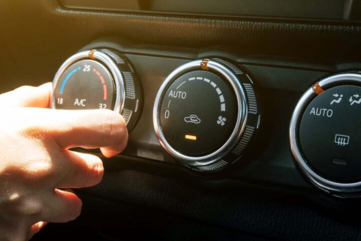 Una persona regola l'aria condizionata in auto