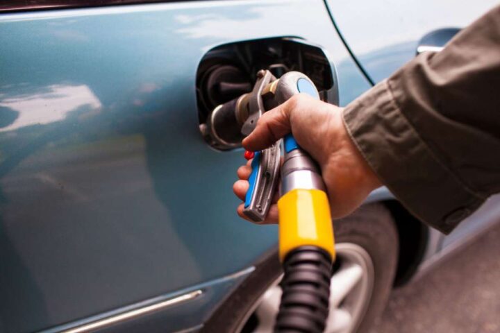 Un uomo rifornisce un'auto a GPL