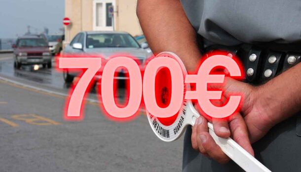 scritta 700 euro con dietro un finanziere